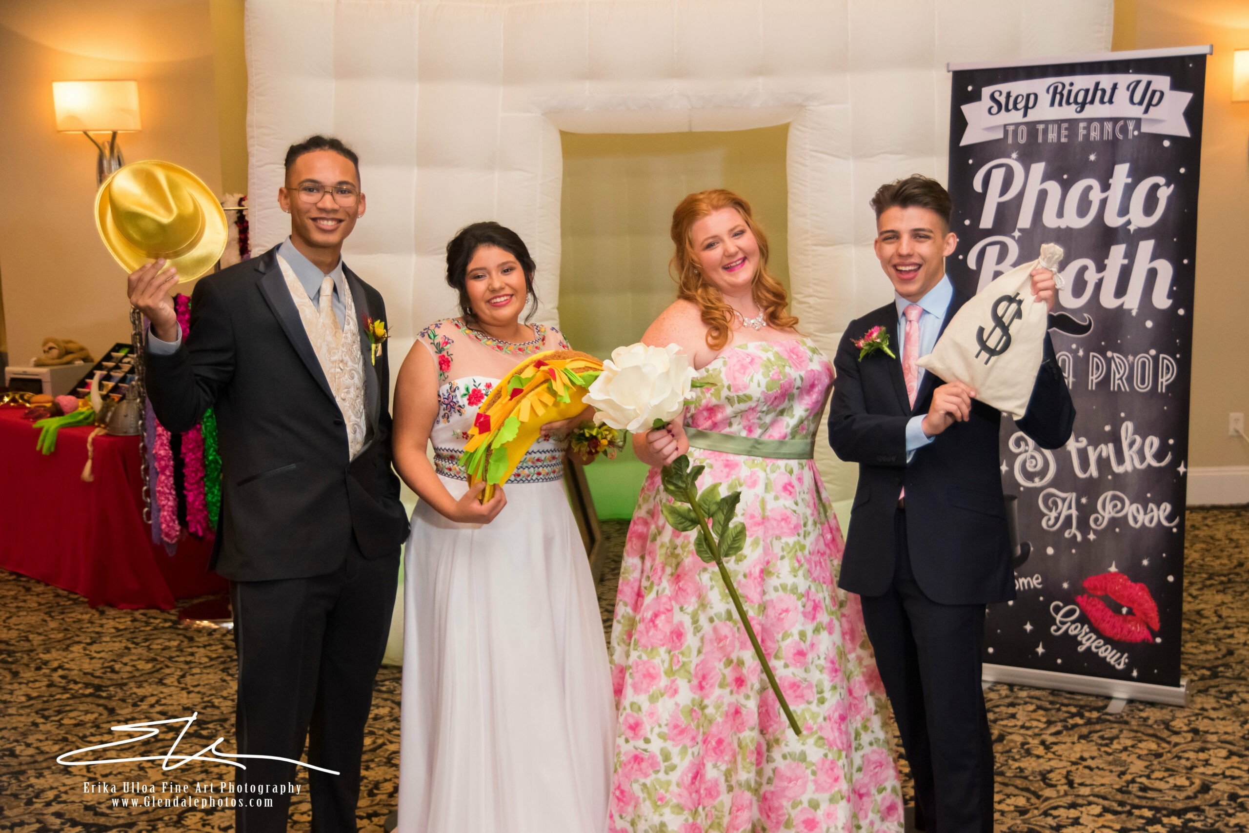 Wedding guests pose at a photo booth.