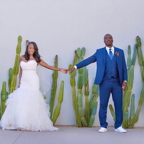 A young newly wedded couple poses for a photo.