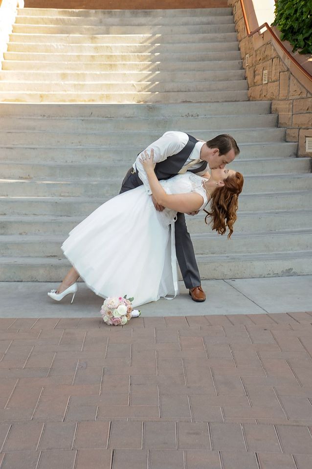 A memorable moment of a groom kissing the bride is captured by MJK Events.